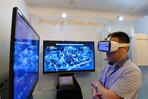 嘉賓在峰會現(xiàn)場利用VR設(shè)備觀看5G測試外場。